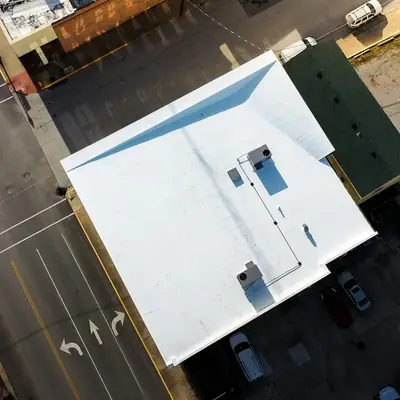 Aerial view of a white flat commercial roof