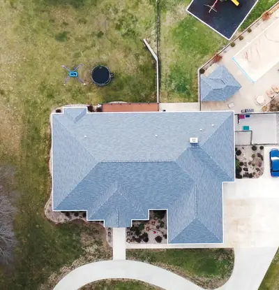 Aerial view of a finished shingle roof on a single-family home